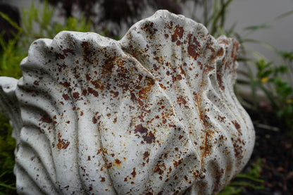 close up view of aged leaf urn