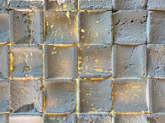 blacklit travertin mosaic with warm light